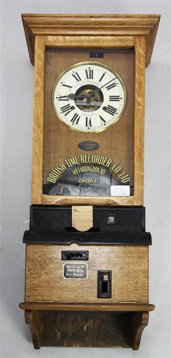 An early 20th century oak British Time Recorder Co. Ltd clocking-in wall clock, H. 3ft 9in.(-)